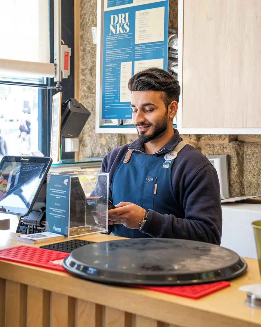 Smiling staff member behind Traveller’s counter