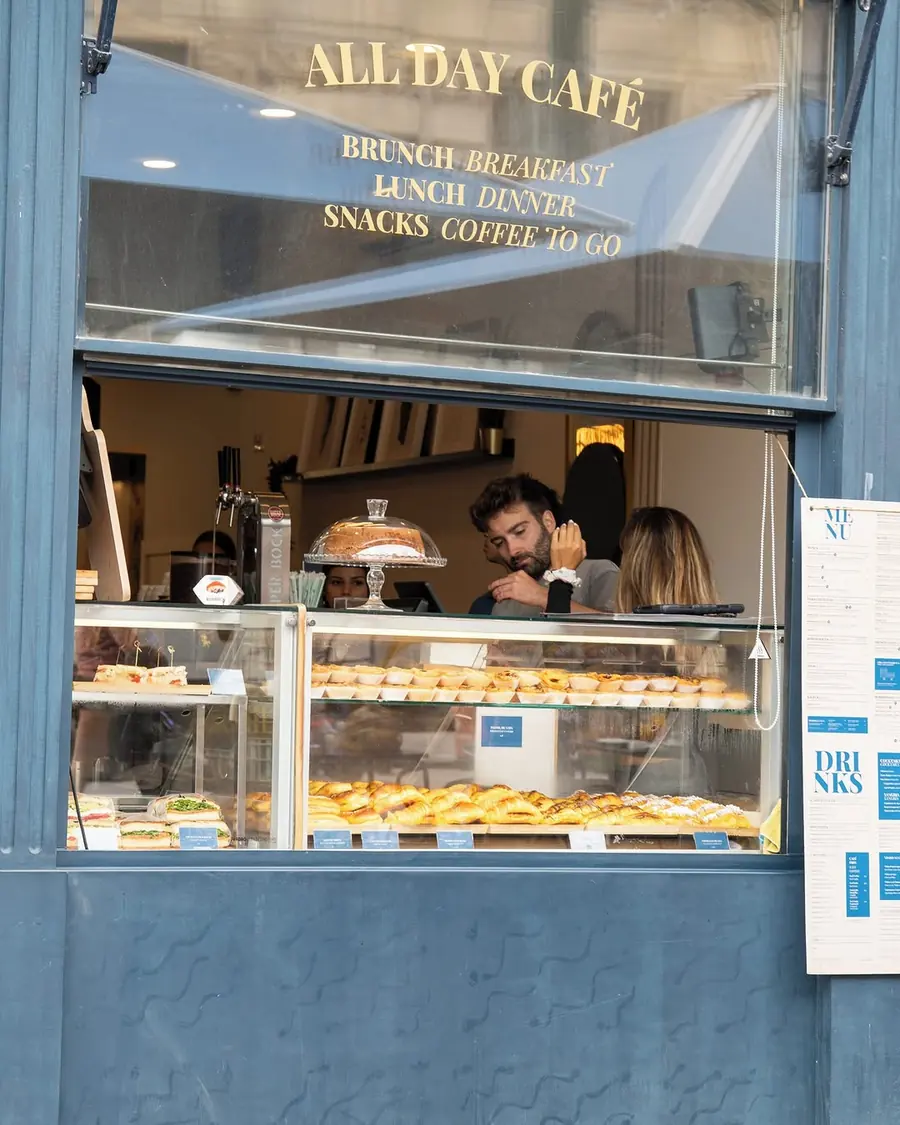 Traveller’s front window lettered All Day Café, with the pastry counter seen from the street