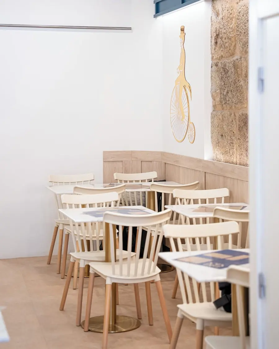 Dining room with light wooden tables and stone walls