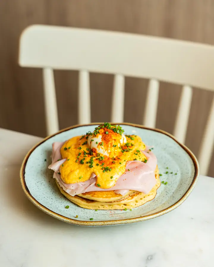 Eggs Benedict with ham and hollandaise sauce on a pancake