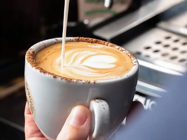 Latte with leaf latte art, served at the counter