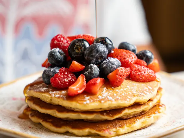 Pancakes with mixed berries and maple syrup